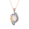 Gold-tone phoenix pendant necklace with blue enamel and white faux jade stone on a wooden surface