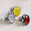 Three vintage style rings with flower charms and faux agate stones in white, red and yellow