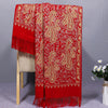 Red rayon shawl draped over a chair showing gold-tone cashew flower embroidery and fringe details