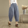 Model wearing blue grey cotton linen harem pants with hands in pockets