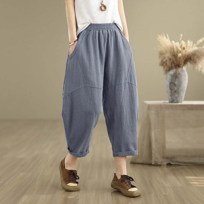 Model wearing blue grey cotton linen harem pants with hands in pockets