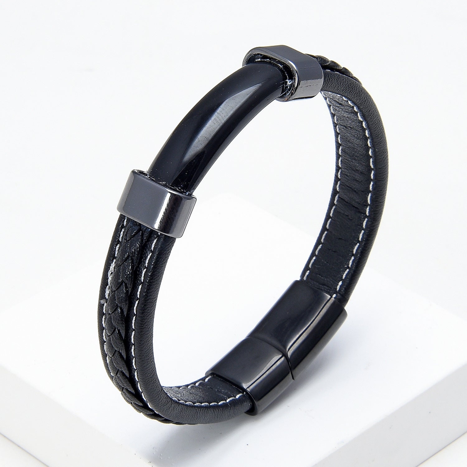 Black braided leather bracelet with a polished stone bar and metal clasp