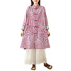 Woman wearing a pink printed cotton coat with frog buttons