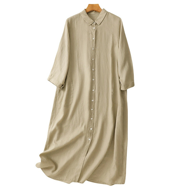 Beige long sleeve cotton midi dress with buttons and pockets on a hanger