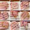 Hand holding a beaded crystal bracelet with purple and pink stones and a gold charm